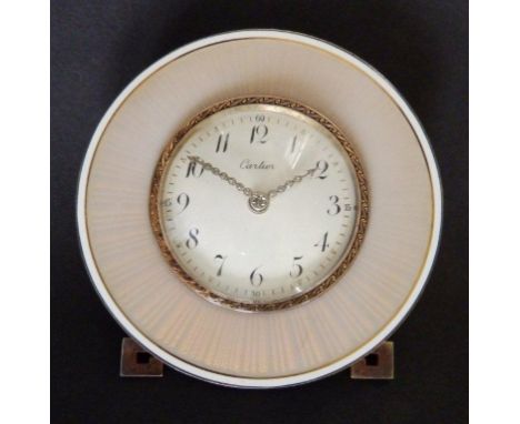 An early 20thC Cartier enamelled silver-gilt travelling clock, the circular white convex dial with diamond set hands, within 