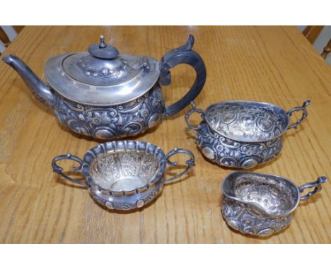 A three piece embossed silver bachelor's tea service – WH & Co, London 1894 and a Birmingham cream jug  (4) 