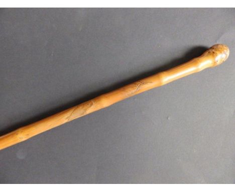 A signed Japanese bamboo walking stick carved with a carp to one side 