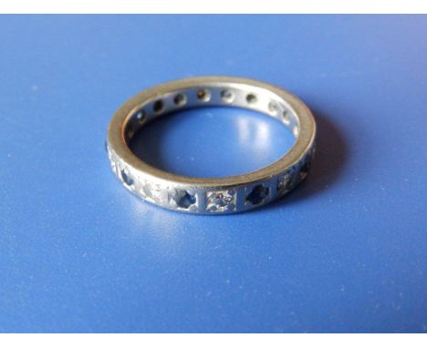 A diamond & sapphire set platinum eternity ring 