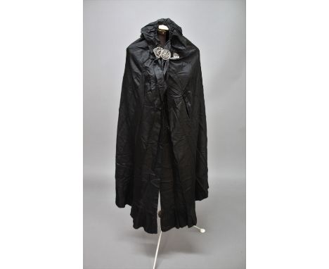 VINTAGE CLOTHING including a late 19thc/early 20thc black silk cloak with white metal buckle fastening, a green felt waistcoa