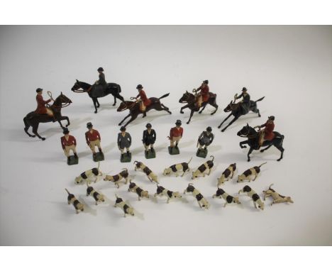 BRITAINS HUNTING SET including 6 figures on horseback, 6 standing figures with riding crops, and 16 hounds in various poses. 