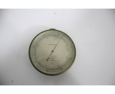 T WHEELER - BRASS CASED MILITARY BAROMETER a compensated brass cased barometer with a silvered dial, marked T Wheeler, Scient