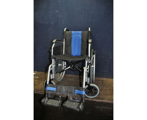 AN ELITE CARE FOLDING WHEELCHAIR with two footrests but no seat cushion