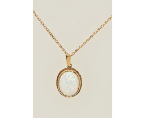 A 9CT GOLD SYNTHETIC OPAL PENDANT AND CHAIN, designed as an oval synthetic opal within a collet mount and rope twist surround