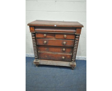 A 19TH CENTURY STAINED PINE SCOTTISH CHEST, fitted with a secret drawer, two short over three long drawers, flanked by bobbin