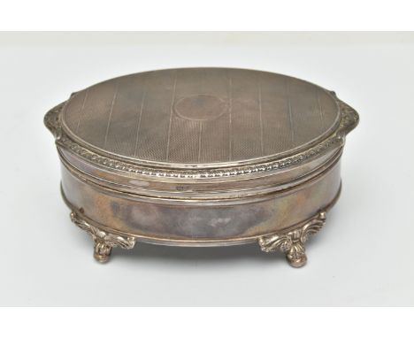 AN ELIZABETH II SILVER TRINKET BOX, oval form box, raised on four scrolling feet, lined with read felt, approximate width 118