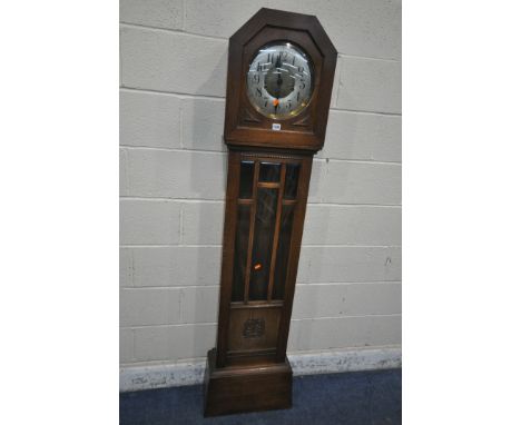 AN EARLY 20TH CENTURY OAK CASED WESTMINSTER GLOCKENSPIEL CLOCK, the circular convex glass door enclosing a 10.5 inch brass an
