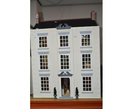 A KIT BUILT DOLLS HOUSE OF A GEORGIAN TOWNHOUSE to include a hand painted three-storey dolls house with wooden and ceramic fu