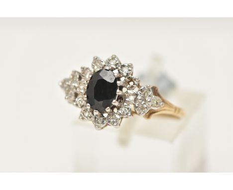 A 9CT GOLD SAPPHIRE AND DIAMOND CLUSTER RING, designed as a central oval sapphire within a single cut diamond surround, stamp