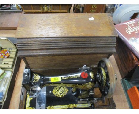 A Singer model F500384 oak cased sewing machine