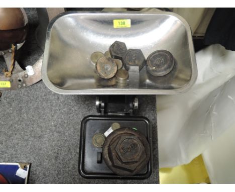 A vintage set of kitchen balance scales with weight set