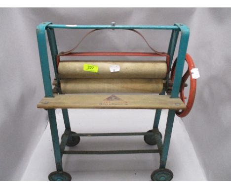 A vintage Tri-Ang child's painted metal framed mangle, some old worm damage to rollers