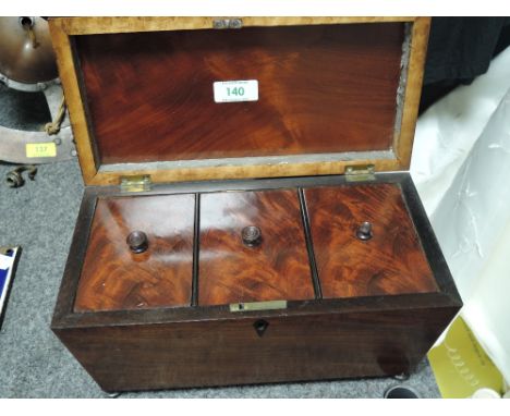 A Victorian casket form tea caddy having mahogany case with fitted interior