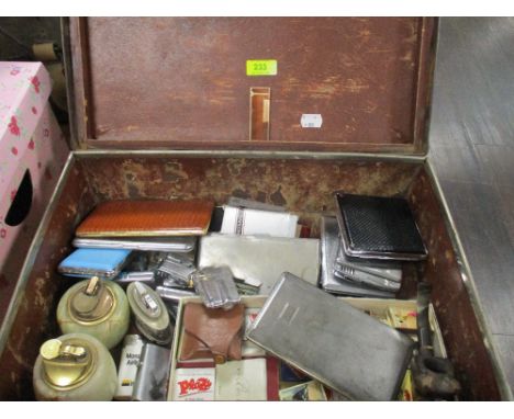 A vintage card leather effect case containing a selection of smoking paraphernalia, cigarette lighters, cigarette cases, pipe