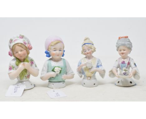 A Goebel porcelain half doll, a child wearing a white floral dress and a grey wig serving tea, impressed mark to back, 10.5 c