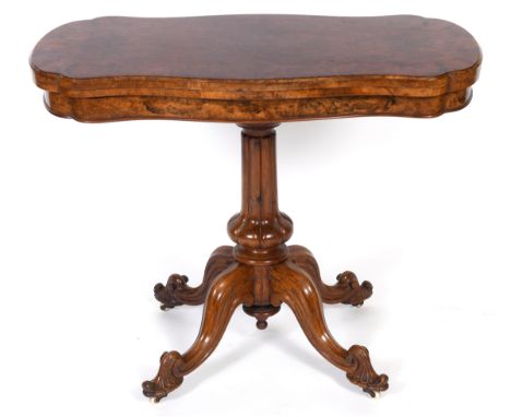 A Victorian card table, the serpentine top veneered in burr walnut on a lobed baluster column and with four downswept legs, w