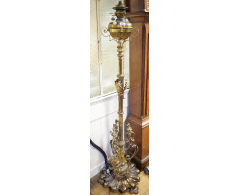 A late Victorian telescopic brass standard oil lamp, decorated acanthus leaves, the reeded column on a lobed base, adapted fo
