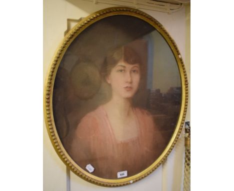English school, early 20th century, a head and shoulders portrait of a young lady wearing a pink dress, pastel, oval, 60 x 50