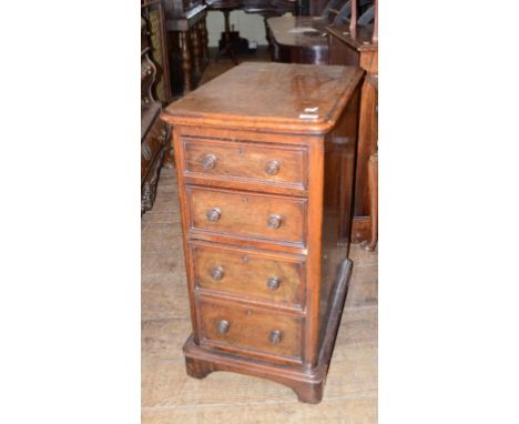 A pedestal chest, veneered in walnut, with four graduated long drawers, 40 cm wide, a set of three Victorian rosewood balloon