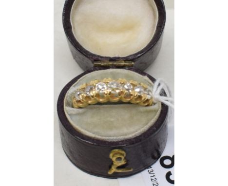 A yellow coloured metal and five stone diamond ring, approx ring size P, apparently unmarked, and a ring box 