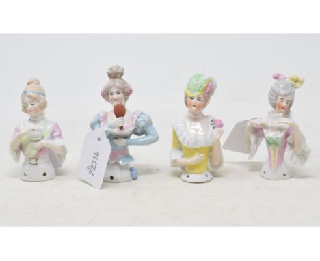 A porcelain half doll, lady wearing a light blue dress holding up a mirror, 9.5 cm high, and three others (4) 