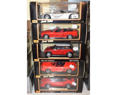 A Maisto 1:18 die-cast model McLaren F1, and four others, all boxed (5) 