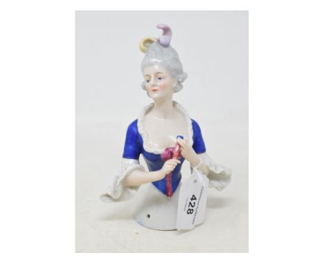 A Goebel porcelain half doll, Marie Antoinette, holding a closed fan, impressed marks to back, 15.5 cm high 