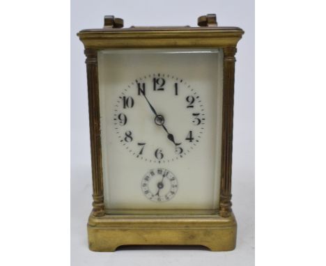A brass carriage clock, with Arabic numerals, striking on a gong, 14.5 cm high 
