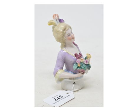 A porcelain half doll, lady with light coloured hair with three feathers and wearing a lilac dress, holding flowers, 12 cm hi