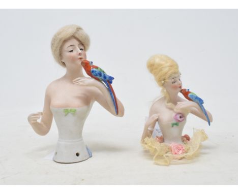 A Goebel bisque half doll, lady with a wig and wearing a white dress, holding a parrot, impressed mark to back, 14 cm high, a