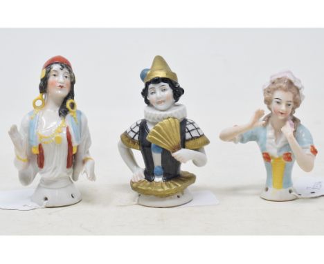 A porcelain half doll, lady wearing a light blue dress, arms up, 8.5 cm high, and two others (3) 