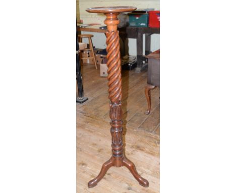 A Victorian mahogany torchere, with a rope twist and lotus leaf carved column, on a tripod base 