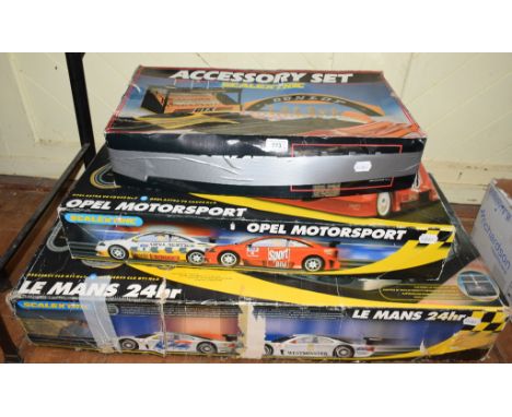 A Scalextric Le Mans 24 hour set, a Scalextric Opel Motorsport set and an accessory set, all boxed, other assorted Scalextric