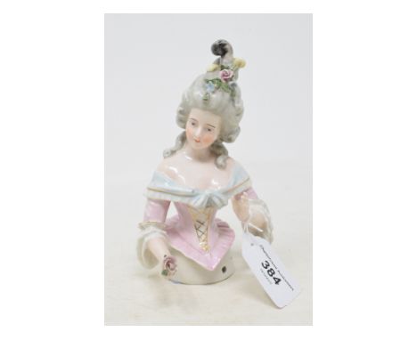 A porcelain half doll, grey hair with flowers and feathers, pink and light blue dress, arms out, impressed no. 9187 to the ba