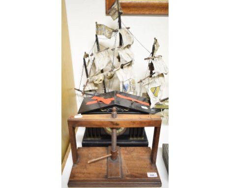 A 19th century tabletop mahogany book press, 30 cm wide, a late Victorian black slate mantel clock, and a model of a three ma