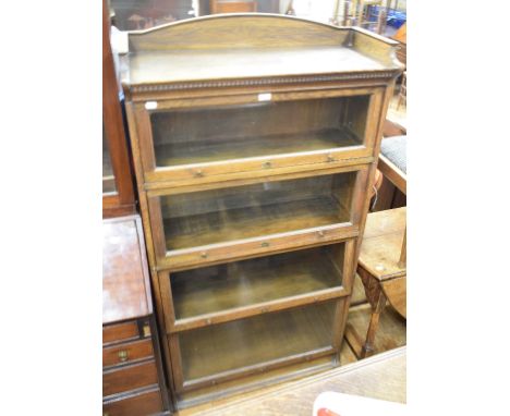 An oak Globe Wernicke style sectional glazed bookcase, 88 cm wide, and a rocking chair (2) 