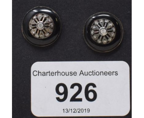 A large pair of stud earrings, set diamonds within a surround of black enamel, boxed 
