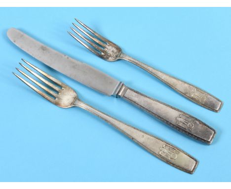 An Adolf Hitler formal pattern silver coloured metal table knife, with a steel blade, with a matching table fork and dessert 