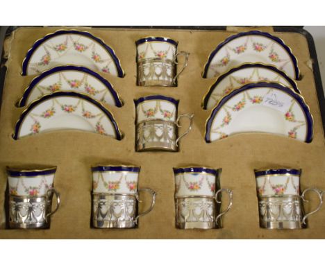 An Aynsley coffee set, the cans with silver holders, some damage, boxed, two sets of silver coffee spoons, a crocodile handba