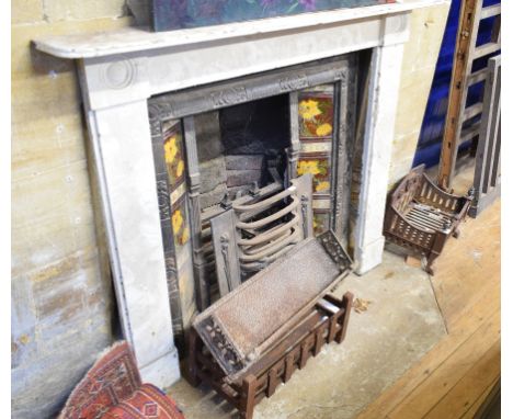 An early 20th century cast iron fire surround, with floral tiles, three fire grates and other fireside items (6) 