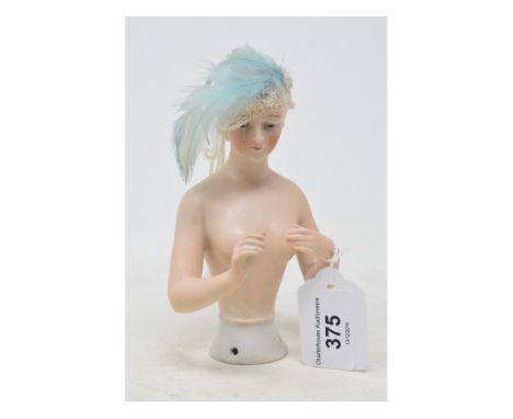 A Goebel porcelain half doll, nude lady round a real fabric cloche with feathers, impressed marks to back, 14.5 cm high 