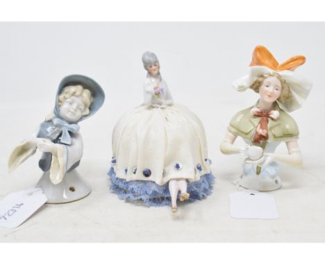 A Goebel porcelain half doll, little girl wearing a grey bonnet with a bow, arms out, impressed marks to back, 9 cm high, and