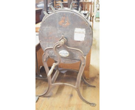 A Kent's Patent Knife Cleaner, on cast iron stand, with ceramic maker's label, 64 cm wide 
