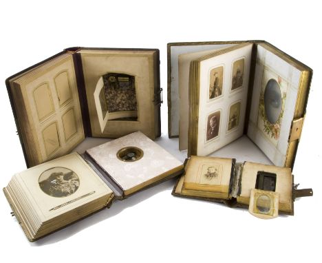 Four musical photograph albums, one of Carte-de-visite size with movement playing two airs, the others larger, with later mov