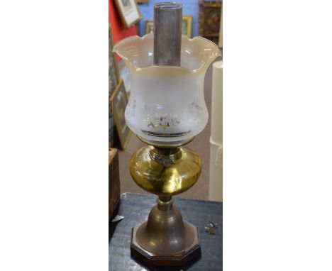 Late Victorian/early 20th century oil lamp with later shade over an amber glass font raised on bell shaped support terminatin