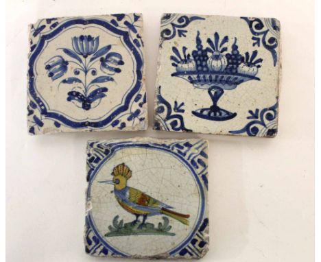 Collection of three 18th century Delft tiles, two with floral and fruit decoration and a further tile with a polychrome decor