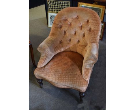 Mid-Victorian mahogany framed button back elbow chair with calix formed short front legs and brass casters, upholstered in pi