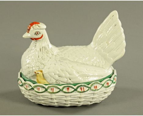 A 19th century Staffordshire hen on nest egg cruet, chick showing, principally white with red comb.  Length 24 cm. CONDITION 