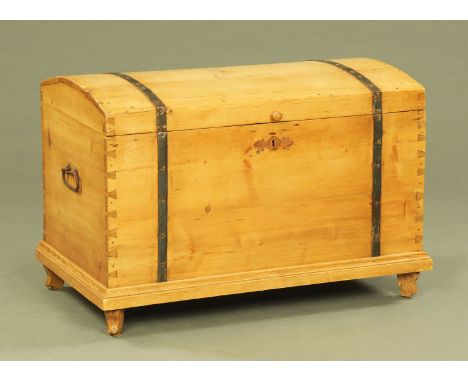 A stripped pine dome topped trunk, with metal bindings and carrying handle to either side.  Width 91 cm.